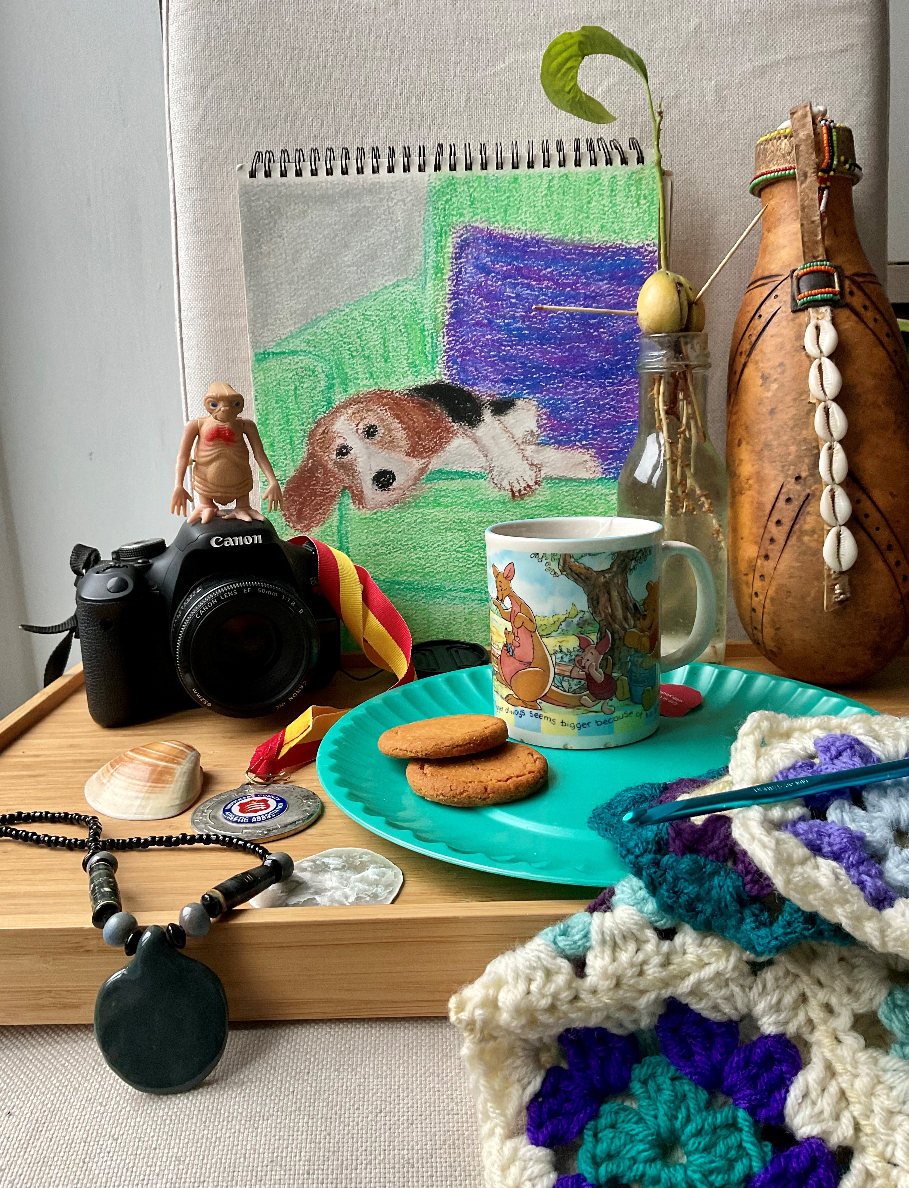Assemblage of objects with a mug and biscuits