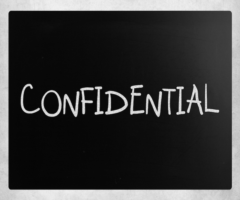 Chalk board showing the word confidential