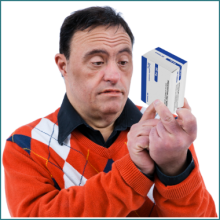 Man reading the side of a medication box